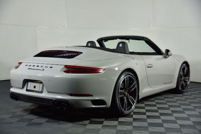 white porsche 911 carrera cabriolet at the collection showroom